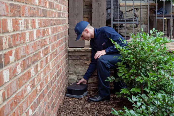 Rocket Pest Control technician in Greenville County setting up rodent bait stations