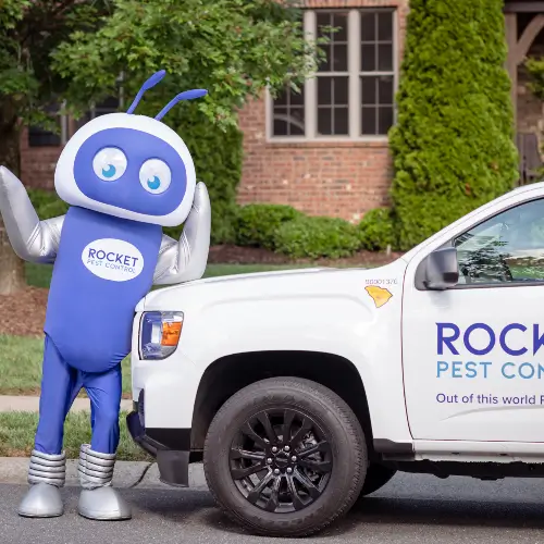 Rocket Pest Control service truck and mascot in Fort Mccoy