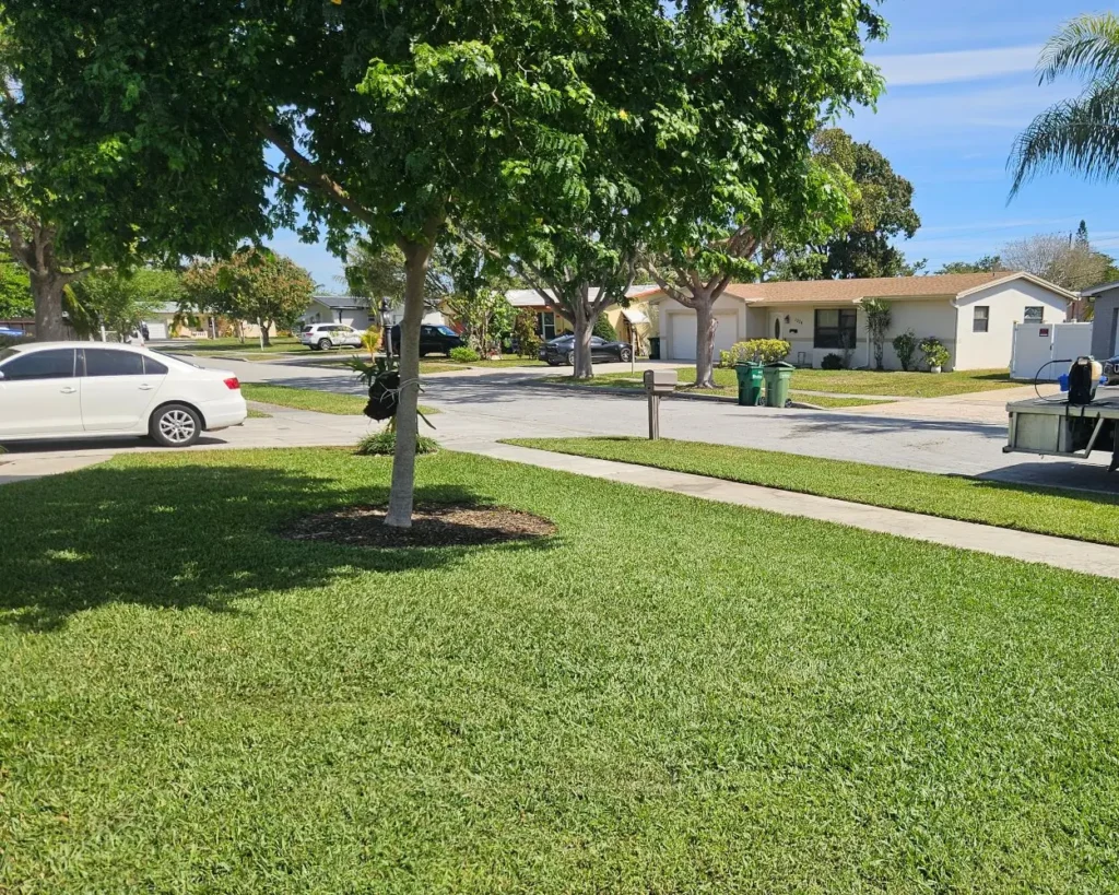 "Well-trimmed front yard lawn with clean edges, serviced by Rocket Pest Control"