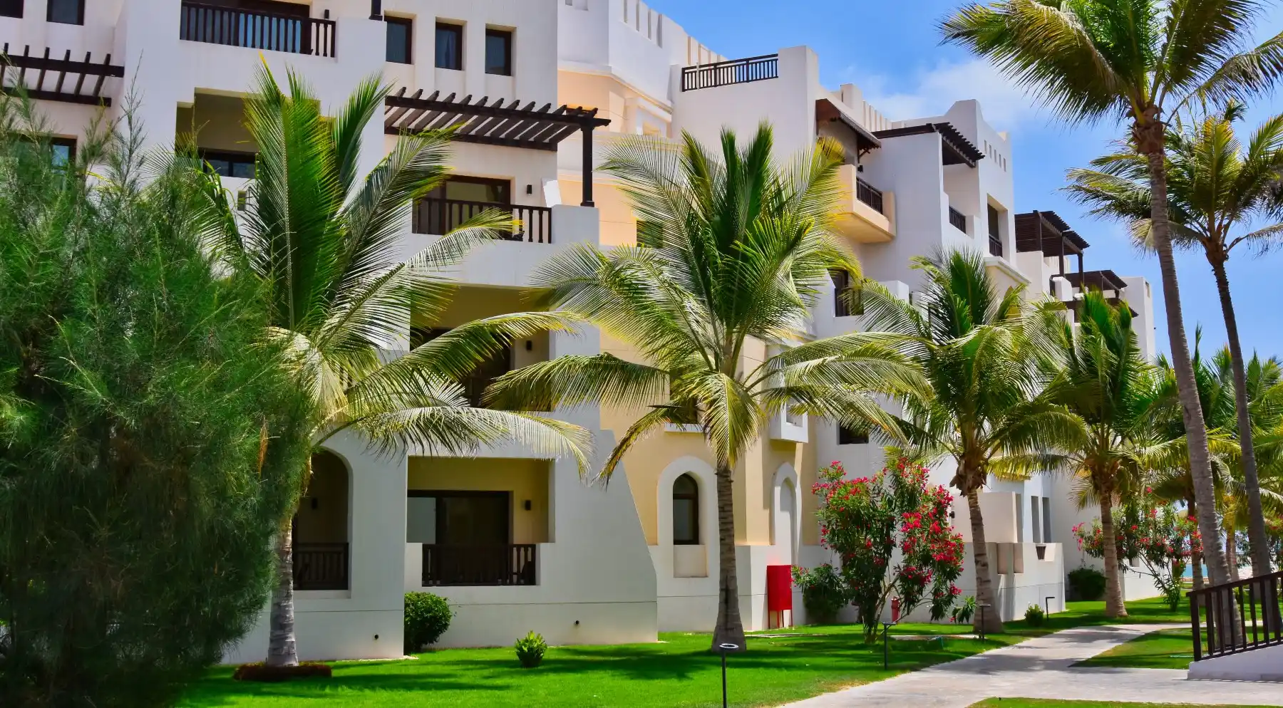 building with multiple palm trees with high quality care and maintenance